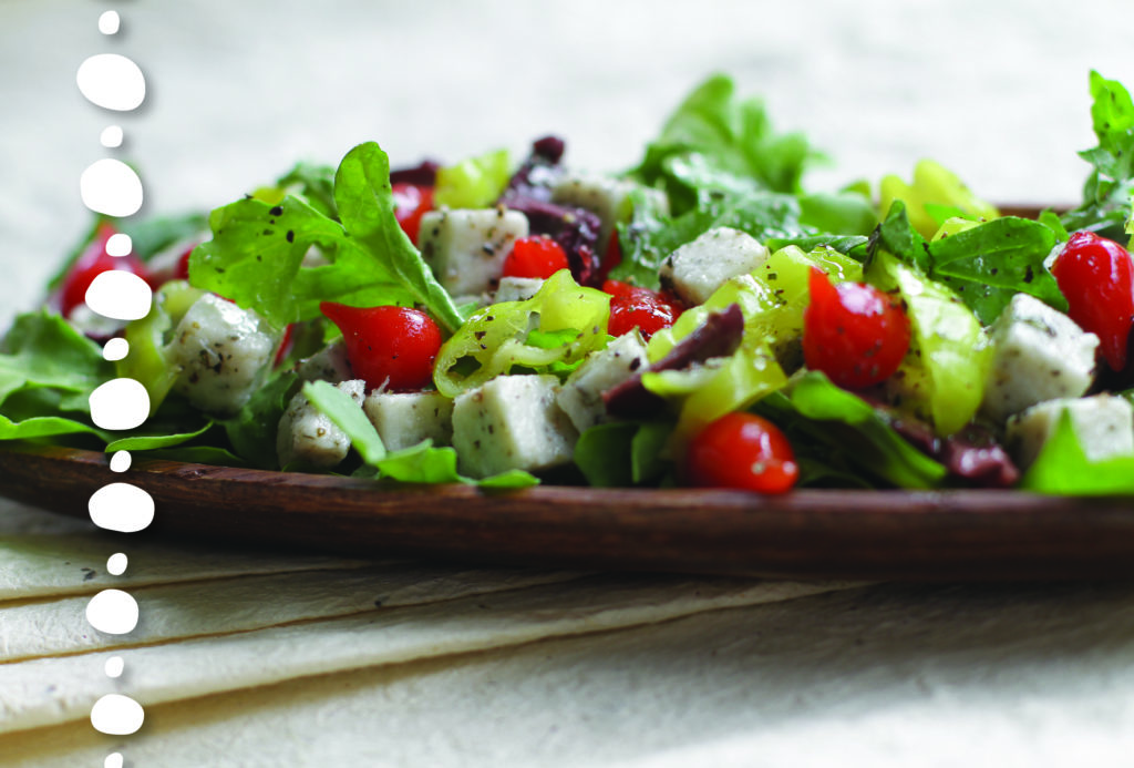 Caprese Salad with fresh greens, sliced tomatoes and some fragrant herbs